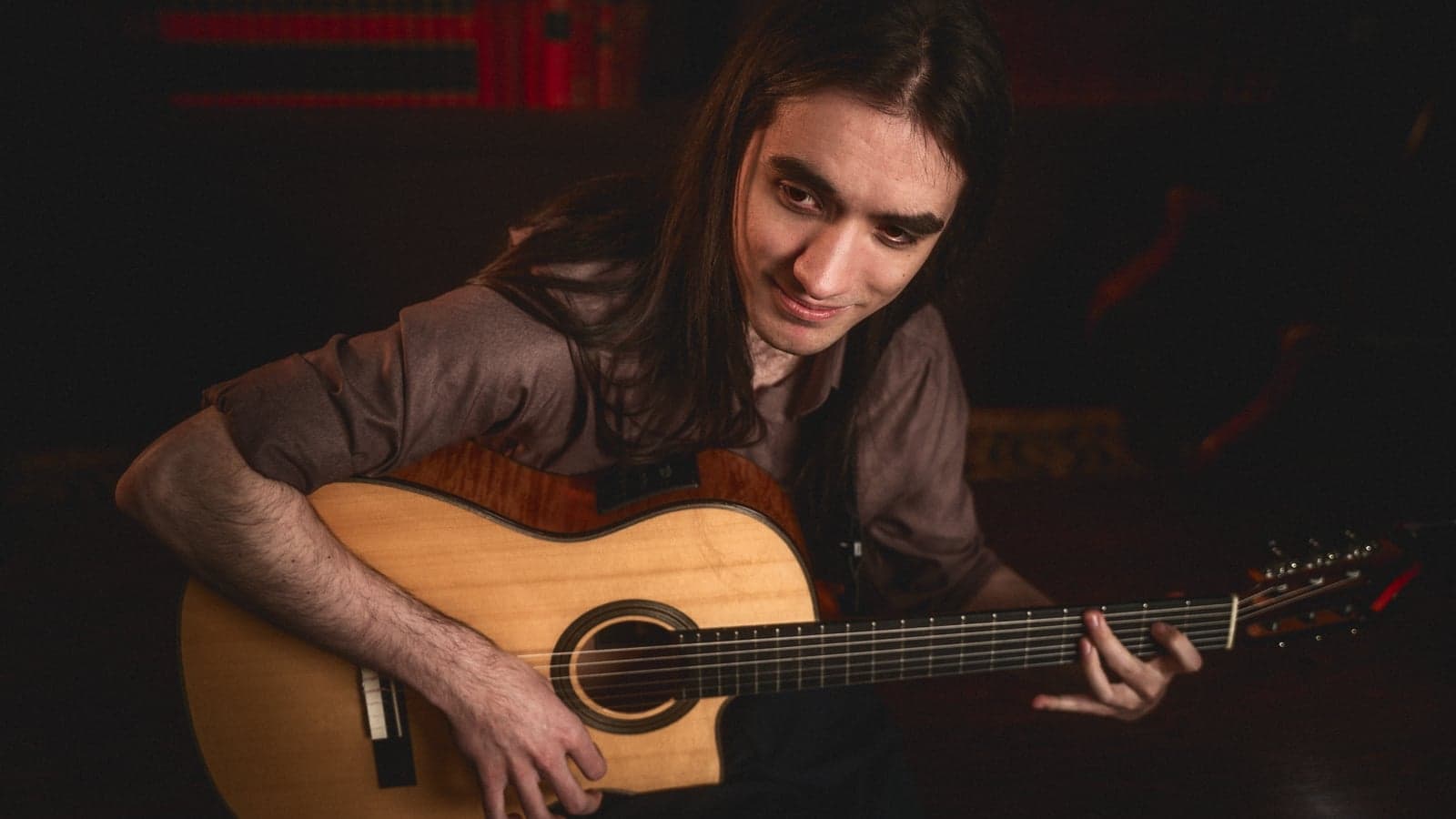 Sam playing guitar in library