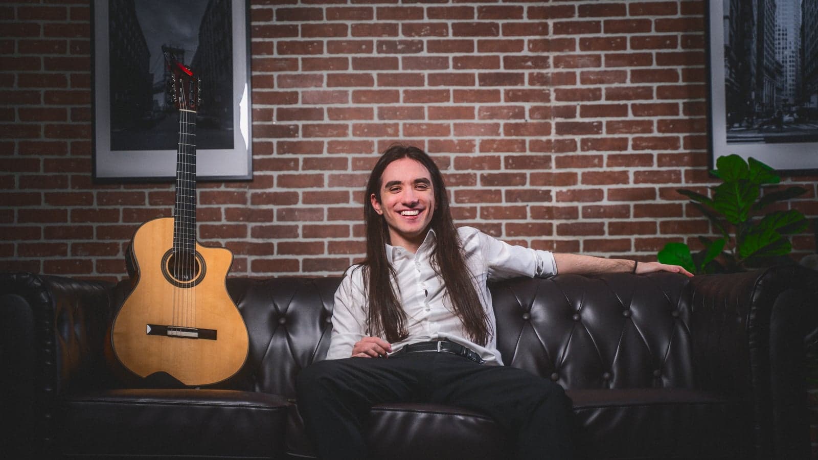 Sam relaxed on couch with guitar