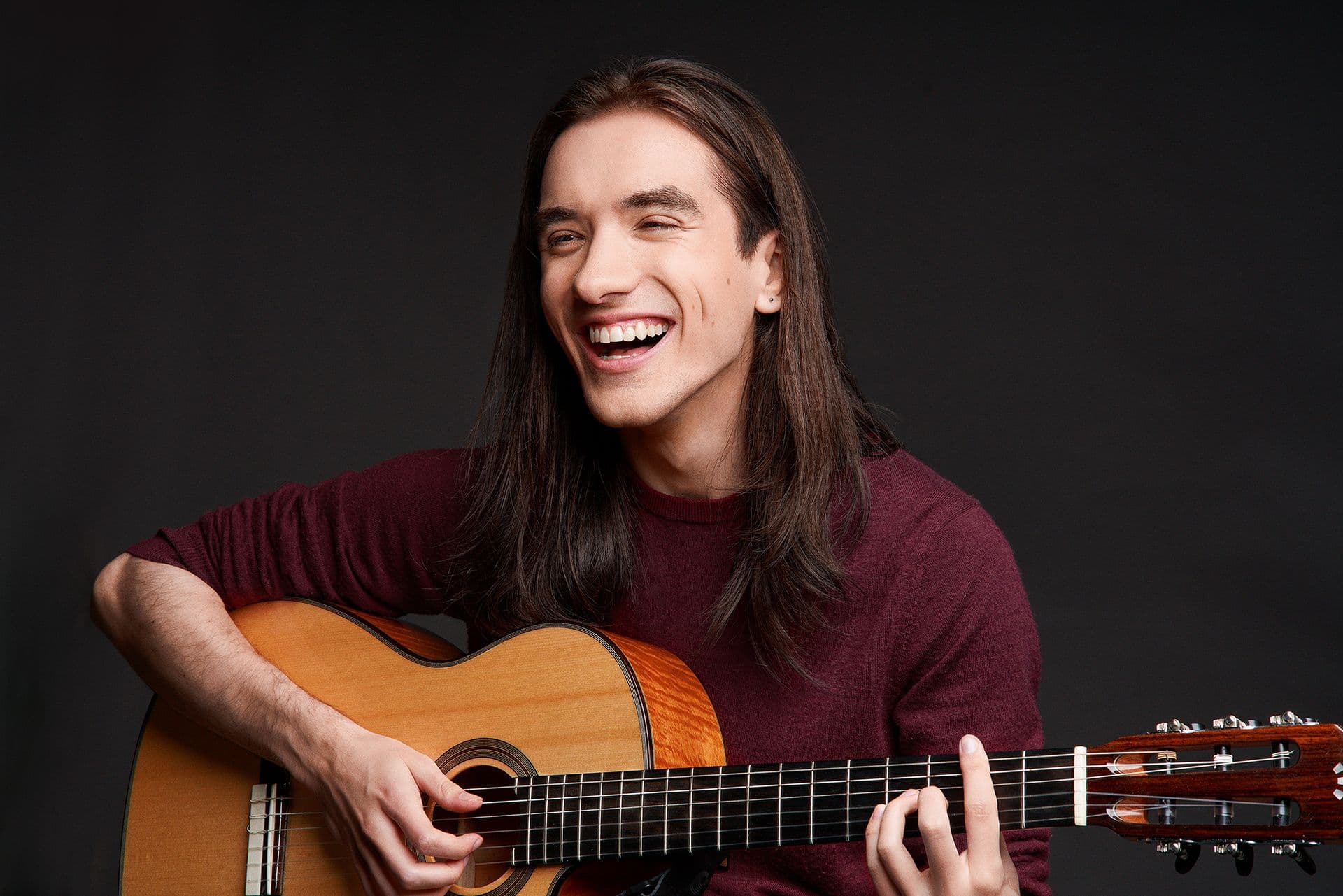 Sam laughing with guitar