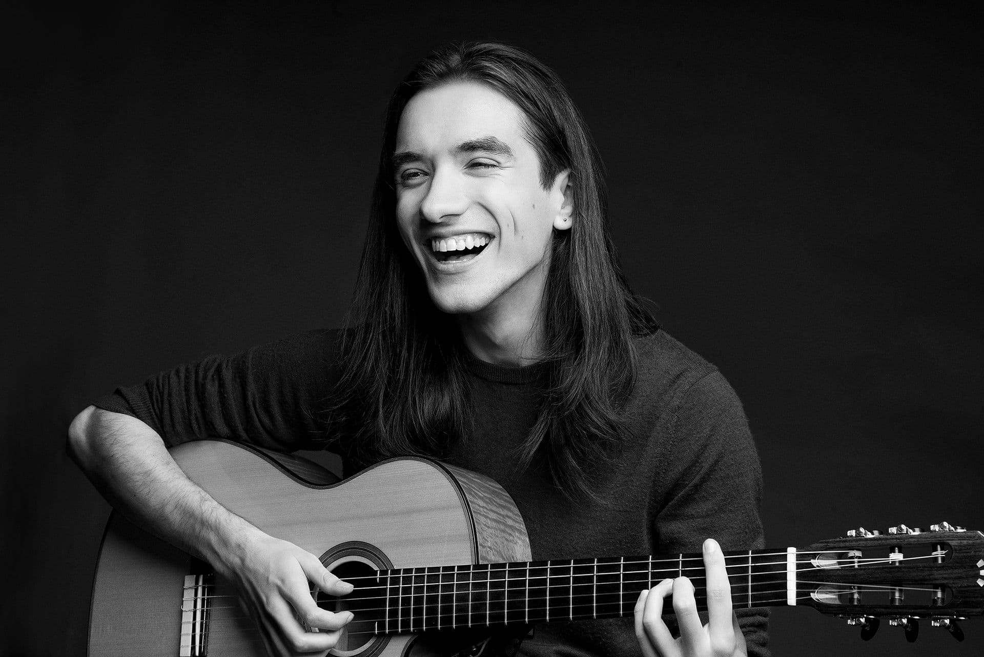 Sam laughing with guitar B&W