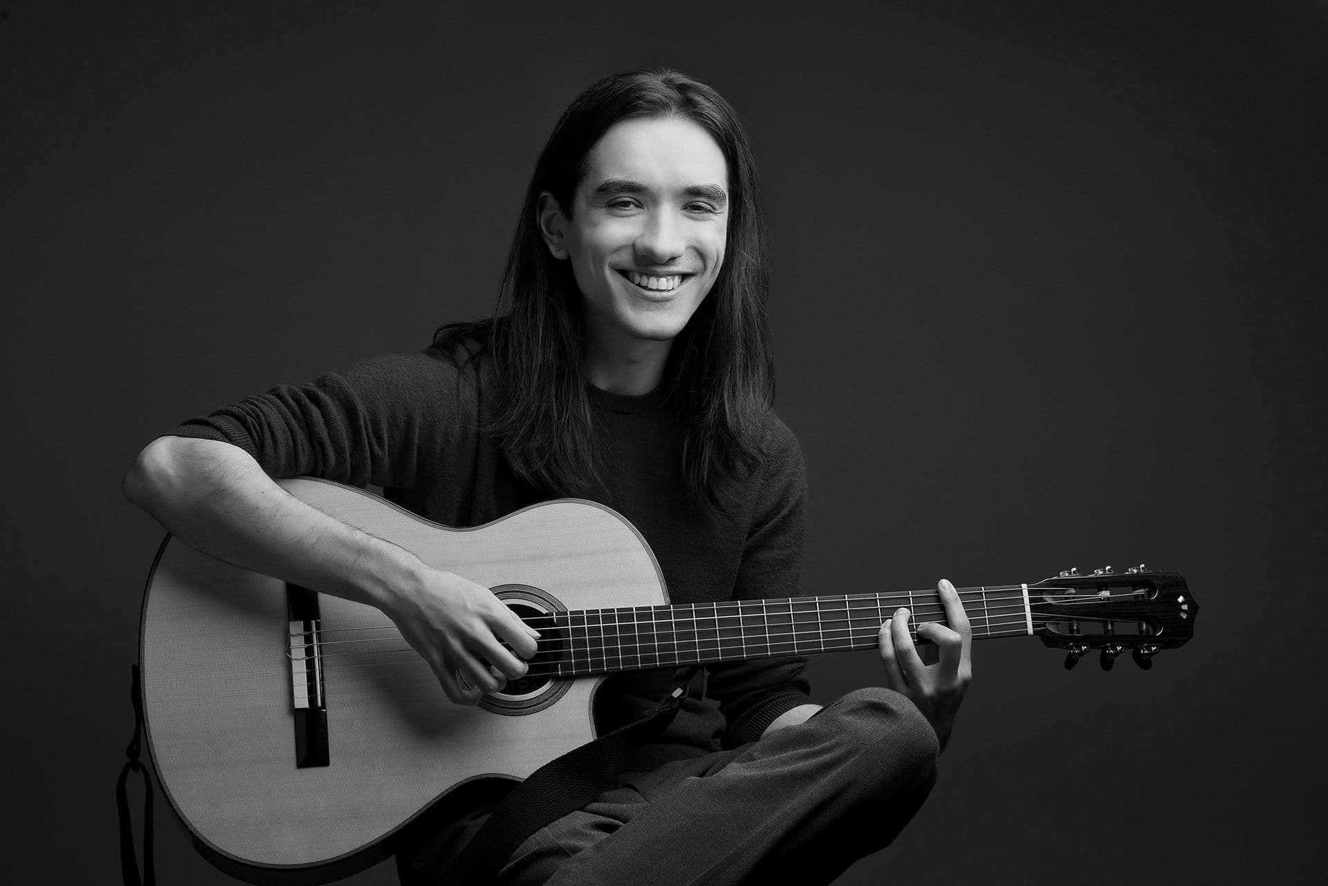 Sam Ellington with guitar B&W