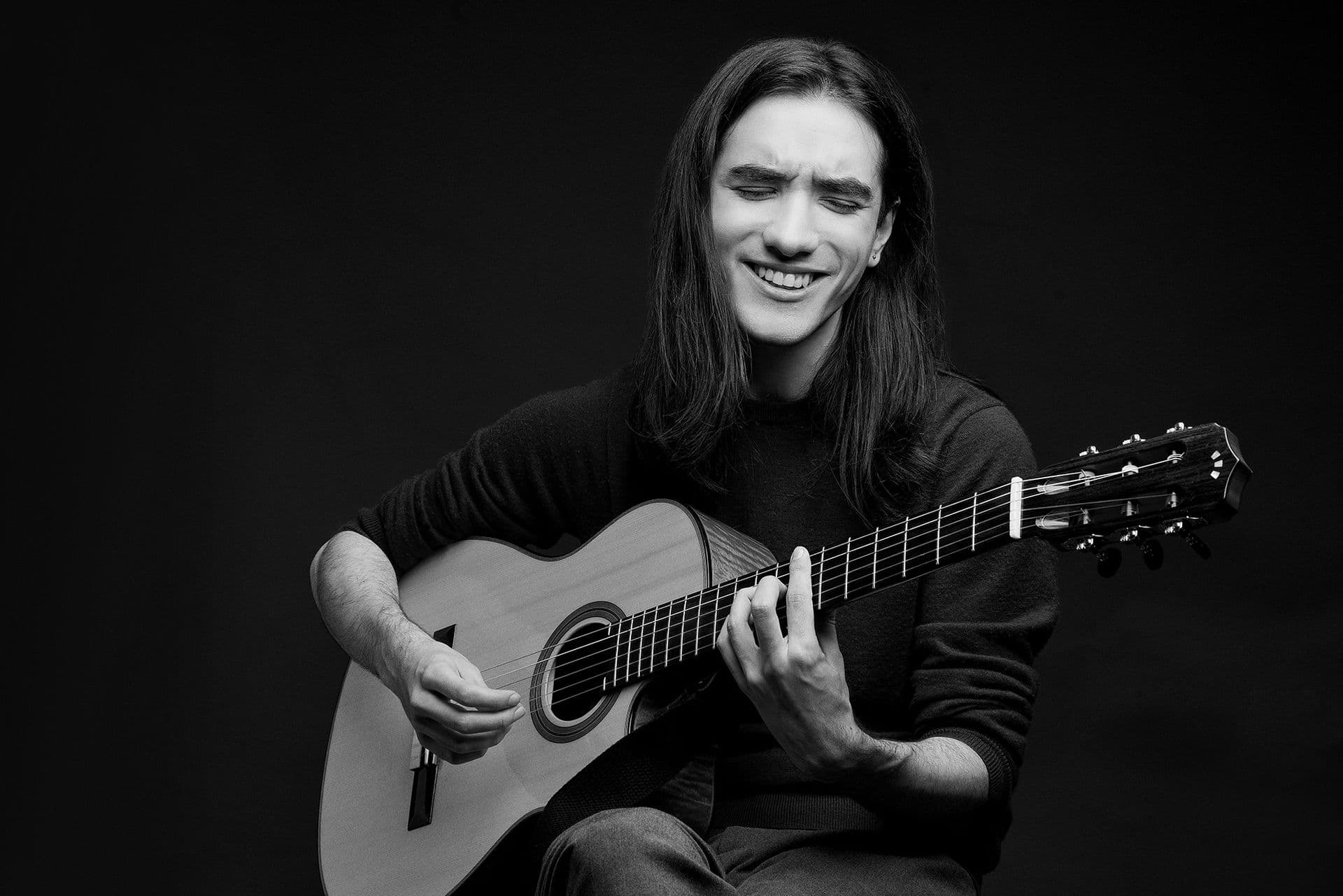 Sam playing guitar B&W