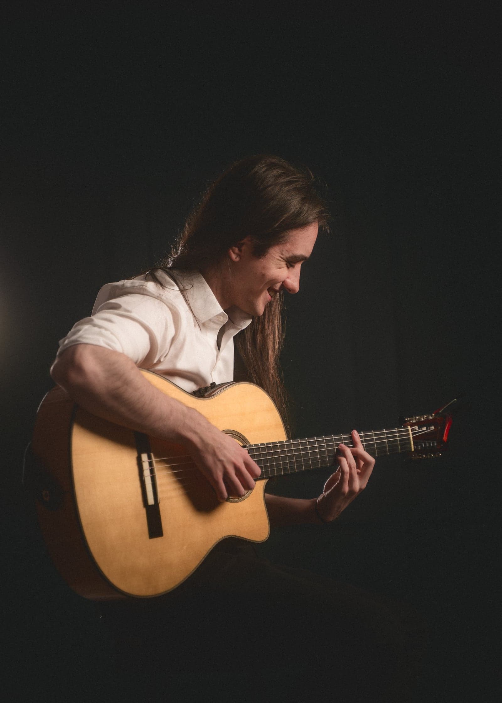 Sam performing guitar, studio